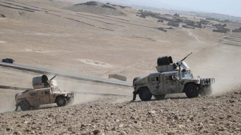 Afghan security officials patrol during an operation against suspected militants, in Chaparhar district of Nangarhar province, Afghanistan, 09 July 2019