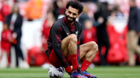 Mo Salah sits on a ball