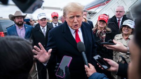 Moline, IL - March 13 : Former President Donald Trump speaks with reporters as he lands at Quad City International Airport in route to Iowa on Monday, March 13, 2023, in Moline, IL