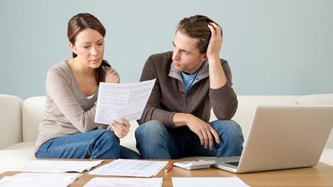 Couple looking worried about bills