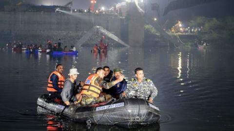 Rescuers at site of collapsed bridge in Morbi, Gujarat state, 31 Oct 22