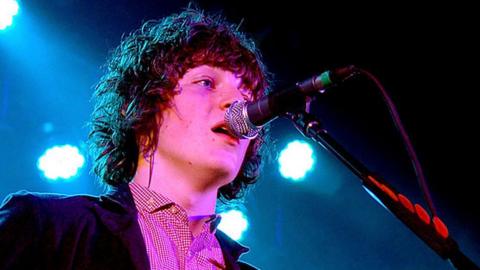 George Craig singing into a mic at a gig