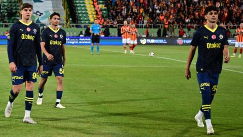 Fenerbahce players leave the pitch