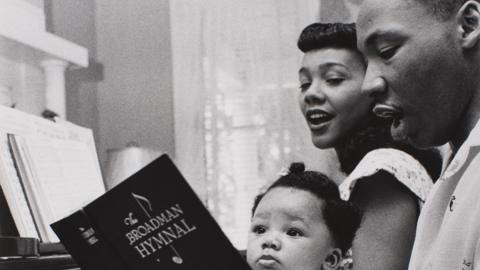 Coretta Scott King, Martin Luther King and one of their children sing a hymn at the piano - Montgomery, 1956