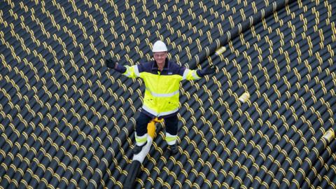Worker standing on coil of subsea cable