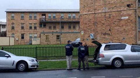 Police officers outside apartments in Melbourne's northern suburbs