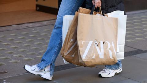 Person with Zara shopping bag