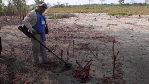 A man hunts for mines manually