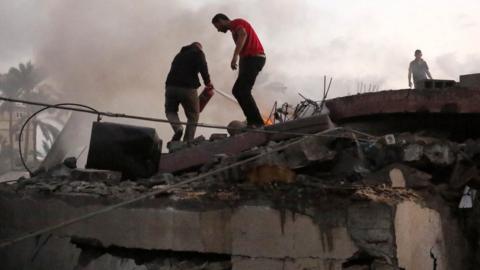Search and rescue efforts continue in destroyed house of Zaydan family hit by Israeli airstrike in Deir Al-Balah, Gaza on October 15, 2023.