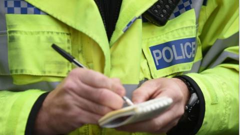 A police officer in a high-vis jacket