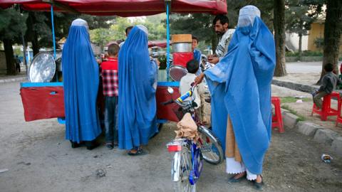 Afghan man with his three wives in Kabul.