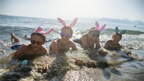 Family on beach in bunny ears