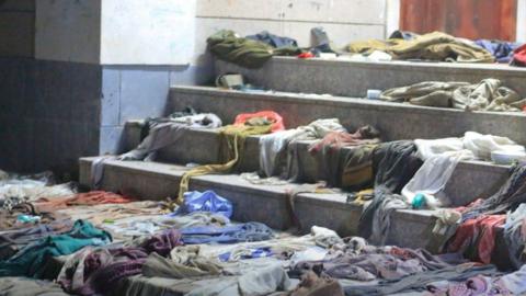 Clothes left on steps leading to the entrance of a school in Sanaa, Yemen, where dozens of people were killed in a crush on 19 April 2023