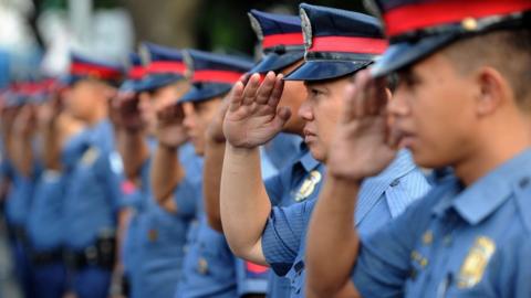 Police in Manila saluting