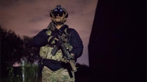 Agent Alex Suarez with the U.S. Border Patrol Tactical Unit (BORTAC) guards the U.S. side of the border wall with Mexico in Brownsville, Texas