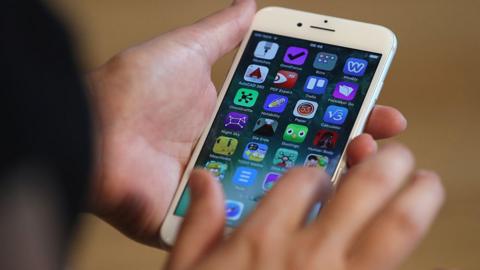 A visitor tries out an Apple iPhone 7 on the first day of sales of the new phone at the Berlin Apple store on 16 September 2016 in Berlin, Germany.