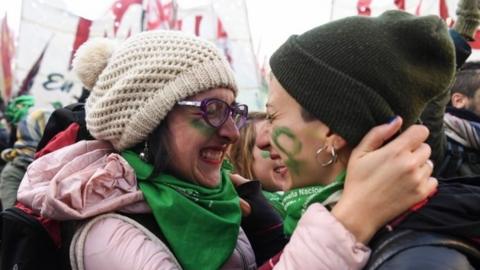 Pro-choice activists react outside the Argentine Congress in Buenos Aires, on June 14, 2018, shortly after lawmakers approved a bill to legalize abortion.