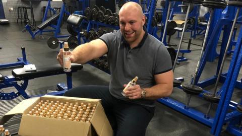 Luke Wilmott with 1,000 bottles of hand gel