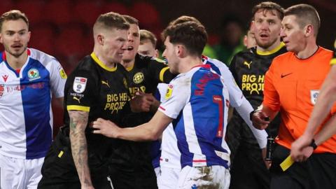 Blackburn and Wigan players clash