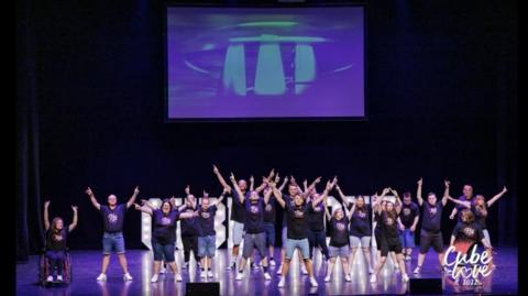 Performers with disabilities on theatre stage.