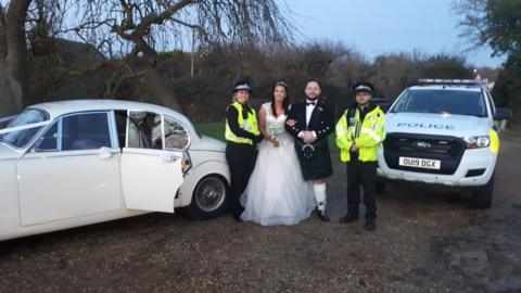 Police officers with the bride and groom