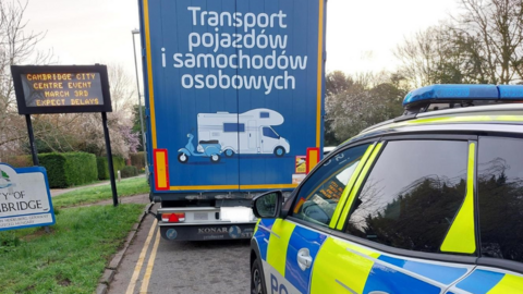 A police car behind an AMBRO Logistics lorry