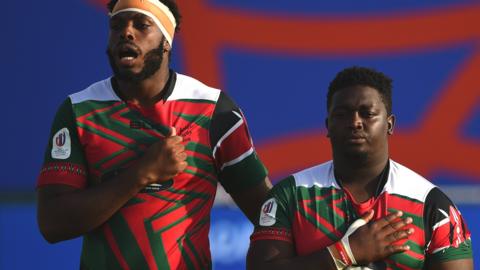 Kenya captain Malcolm Onsando (left) sings the national anthem