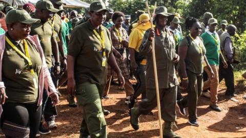 President Yoweri Museveni (front 3rdR) walks during the first day of a 6-day trek