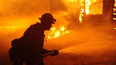 A firefighter with a hose