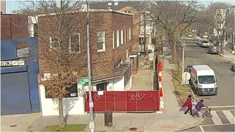 Security footage captures the moment two people narrowly avoided being crushed by falling debris.