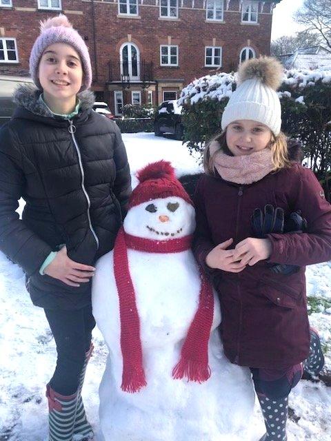 Erin and Meghan were busy building this stylish snow woman, Brenda. Matching hat and scarf? Very nice.