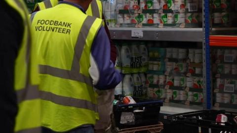 Image of foodbank workers loading food into a bag