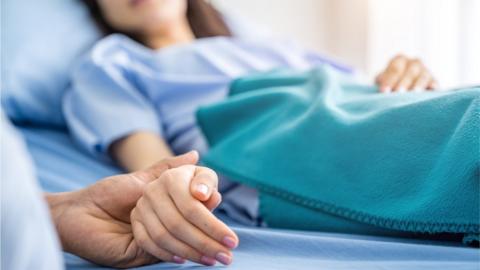 Patient waiting in a hospital bed