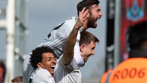 Exeter celebrate scoring a late winner at Northampton Town