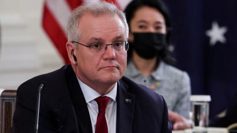 Australia's Prime Minister Scott Morrison is seated with members of his delegation as he participates in a "Quad nations" meeting at the Leaders" Summit of the Quadrilateral Framework at the White House in Washington, US, 24 September 2021