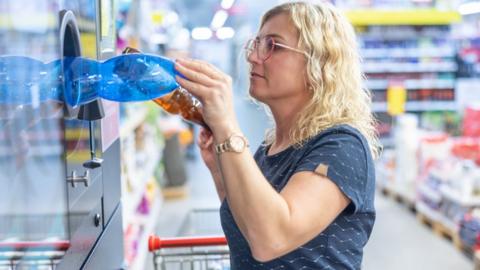 Woman recycles bottles