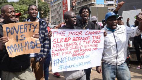 Activists shout slogans while holding placards within the Nairobi's Central Business District (CBD) during a demonstration against the financial bill 2023 that if passed will see the cost of living in Kenya skyrocket.