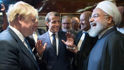 British Prime Minister Boris Johnson (left), French President Emmanuel Macron (centre) and Iran's President Hassan Rouhani (right) discuss at the UN General Assembly in New York on 24 September 2019.