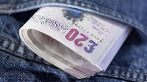 Bundle of twenty pound notes in a back pocket