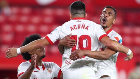 Sevilla's players celebrate scoring against Atletico Madrid