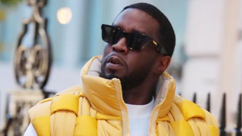 Sean Combs aka Diddy looks on wearing black sunglasses and yellow puffer jacket while out and about on November 10, 2023 in London, United Kingdom