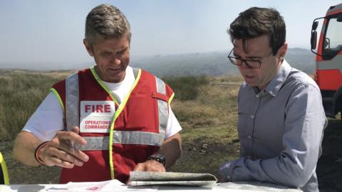 Andy Burnham and a firefighter