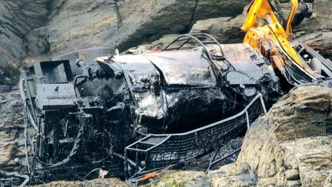 Lorry reversed off cliff