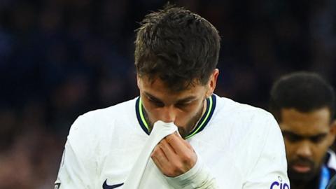 Tottenham midfielder Rodrigo Bentancur walks off the pitch after suffering an injury against Leicester City