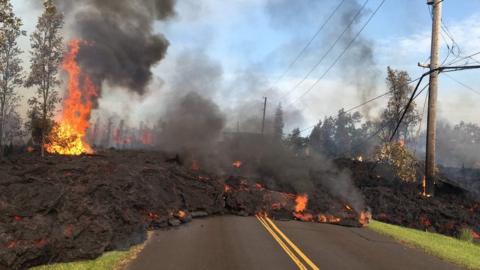 This image released by the US Geological Survey shows lava from a fissure slowly advancing to the northeast on Hookapu Street in Leilani Estates, Hawaii, on May 5, 2018.