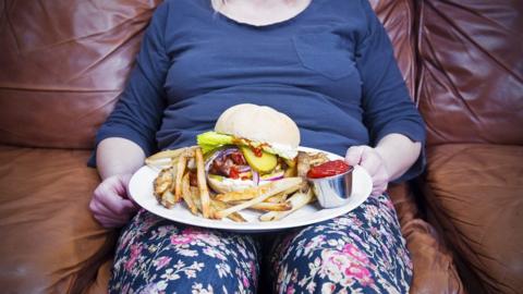 Obese woman with a plate of food