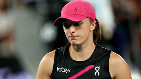 Iga Swiatek looks down