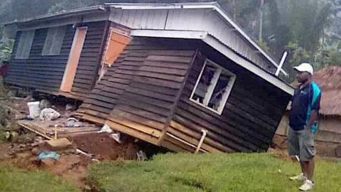 A man stands next to a damaged house near a landslide in the town of Tari after an earthquake struck Papua New Guinea's Southern Highlands