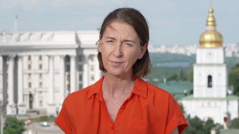 Sarah Rainsford in an orange shirt.