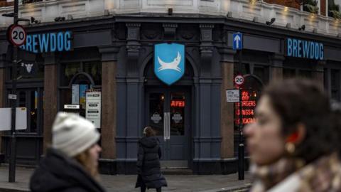 A Brewdog pub with people walking past in the foreground